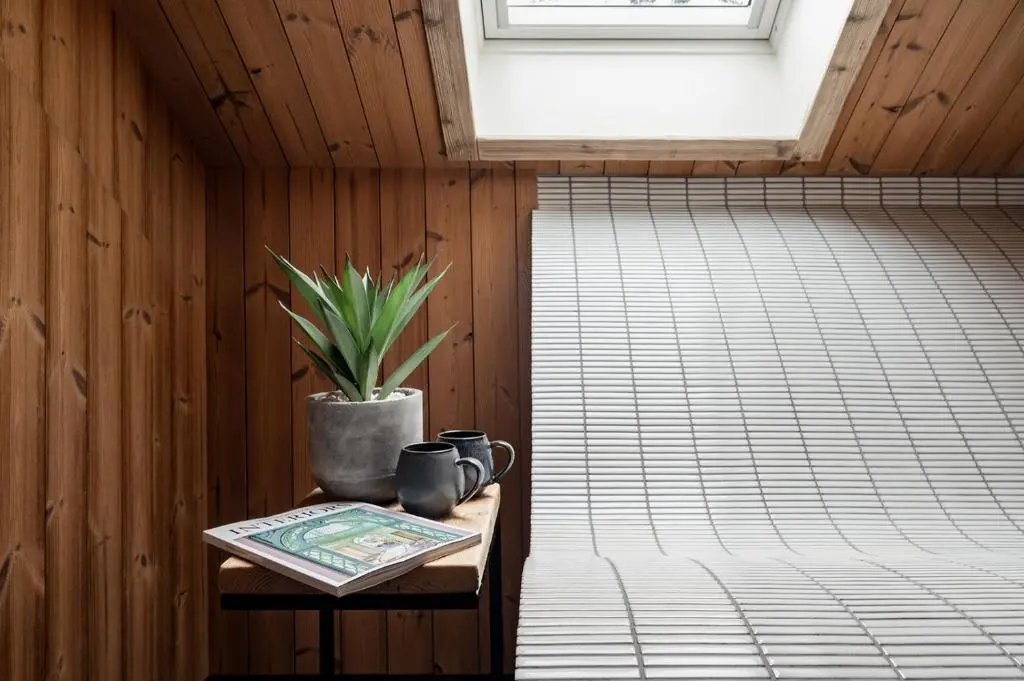 a room with a table with a potted plant on it at Osprey Lodge in Aviemore