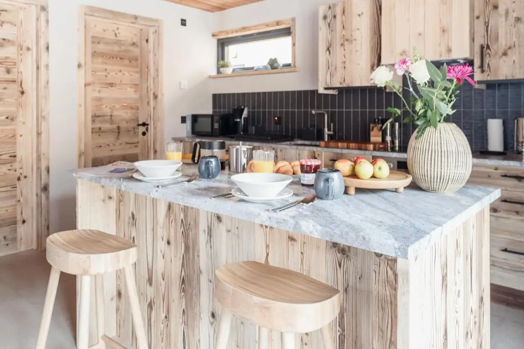 a kitchen with a counter with a bowl of fruit on it at Osprey Lodge in Aviemore