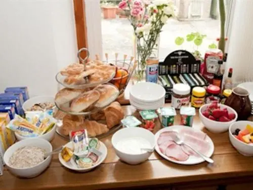 a table with a bunch of bread and other foods at Heathcote B&B in Inverness