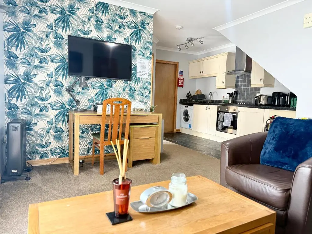 a living room with a couch and a table at The Old Salt House, Flat1 in Wick