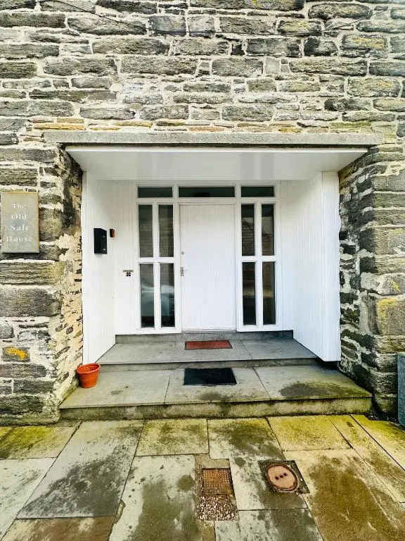 an entrance to a stone building with a white door at The Old Salt House, Flat1 in Wick