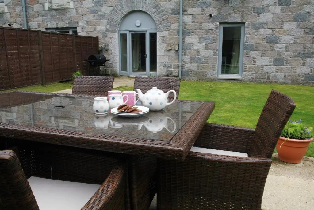 a table with a tea set on top of it at Abbey Garden at the Highland Club in Fort Augustus