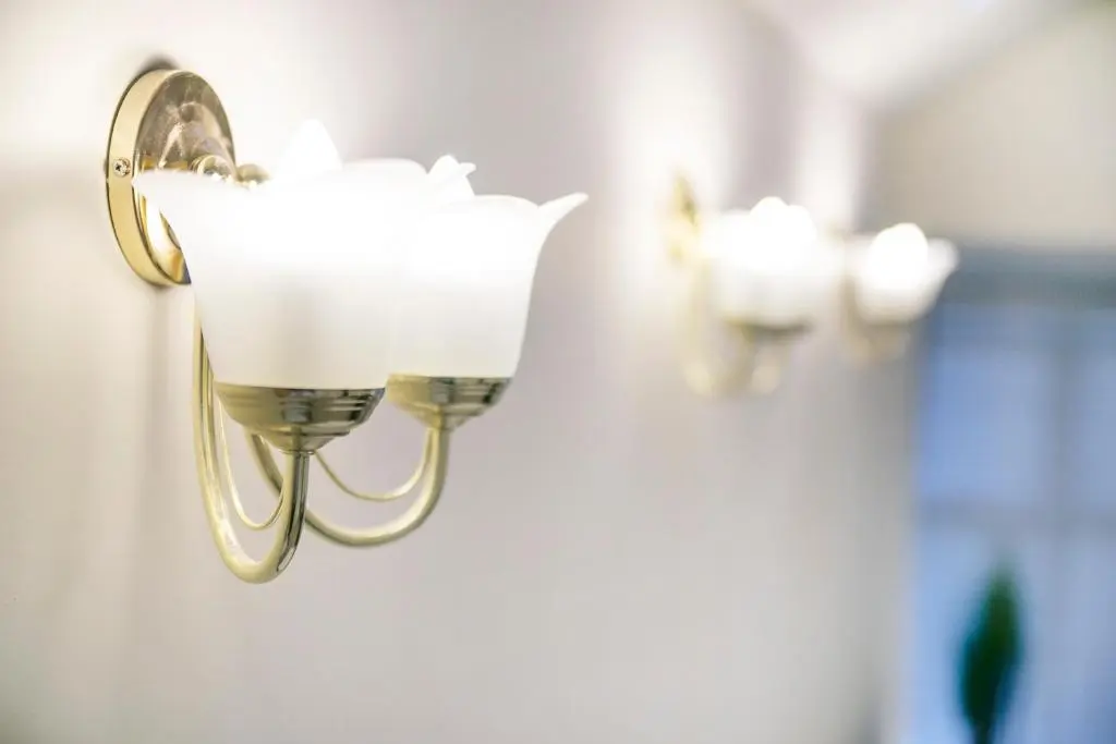 a wall light with a flower on a wall at Constancevilla B8 - Grampian Lettings Ltd in Aberdeen