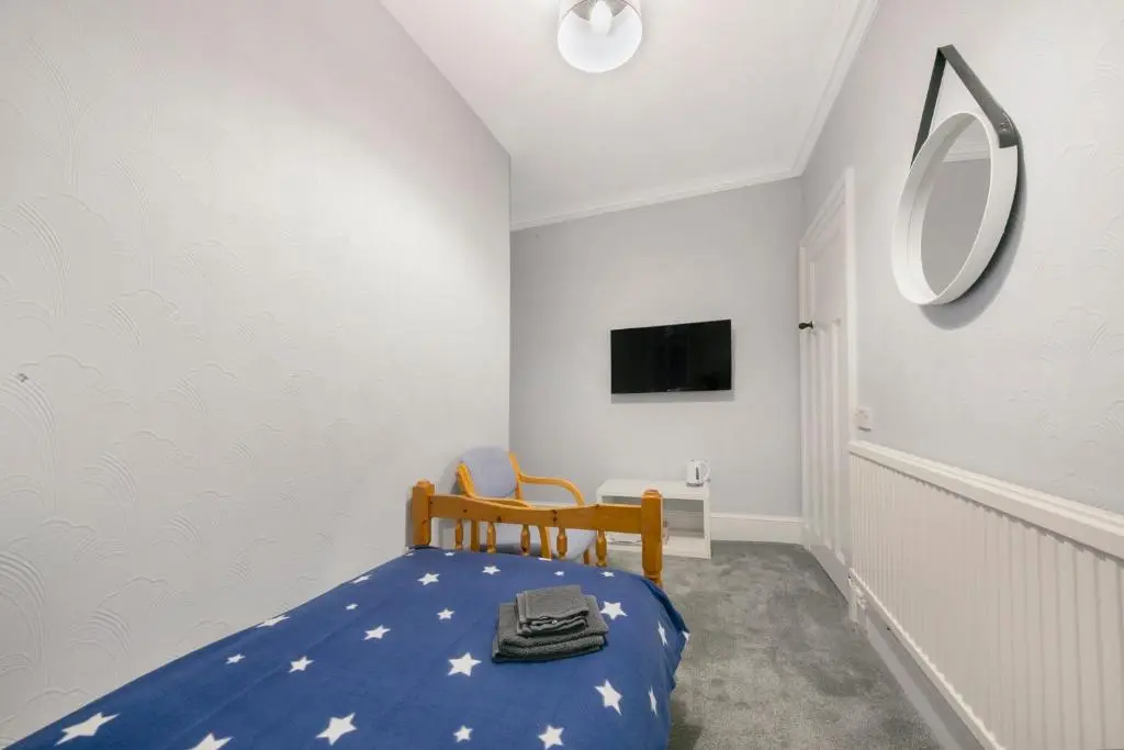 a small bedroom with a blue bed with stars on it at Constancevilla B8 - Grampian Lettings Ltd in Aberdeen