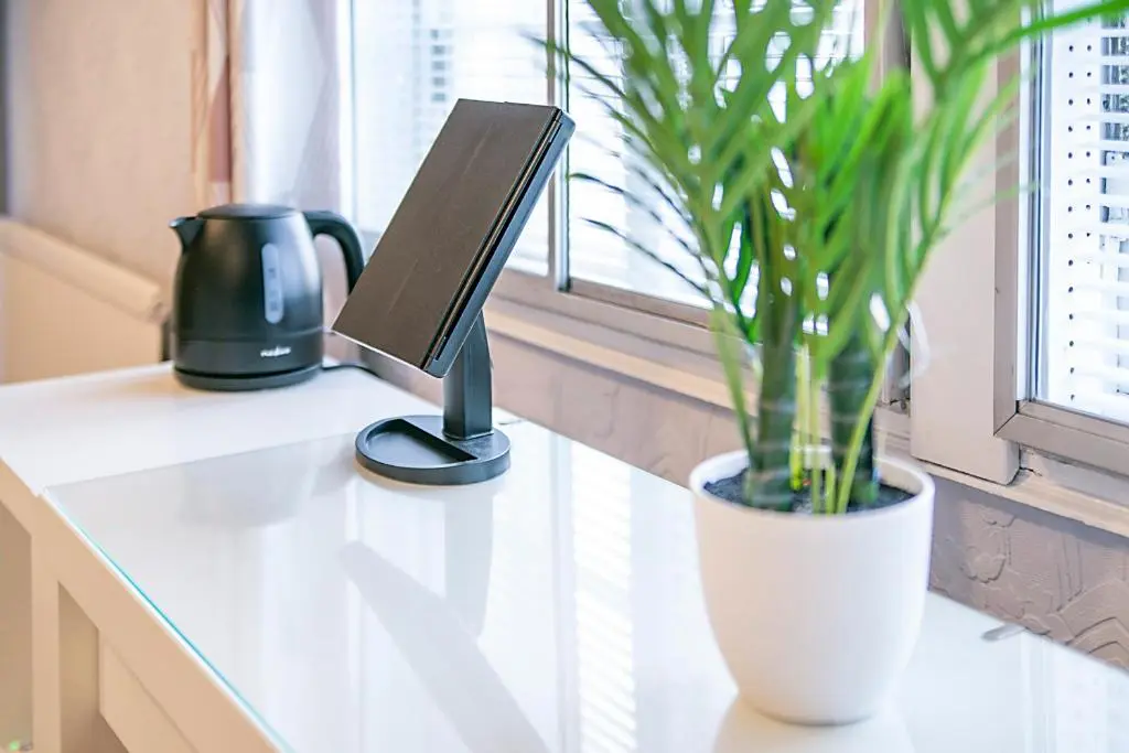 a desk with a computer monitor and a potted plant at Constancevilla B8 - Grampian Lettings Ltd in Aberdeen