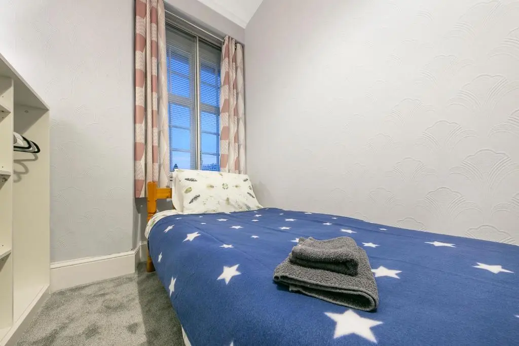 a bedroom with a blue bed with stars on it at Constancevilla B8 - Grampian Lettings Ltd in Aberdeen