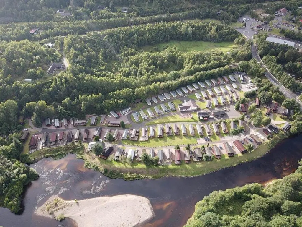 an aerial view of a resort complex next to a river at Cabin 38 in Aviemore