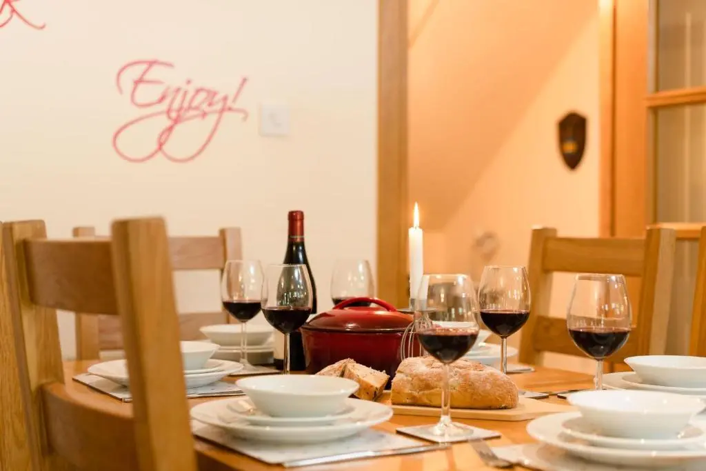 a table with glasses of wine and bread on it at Bracken House in Aviemore