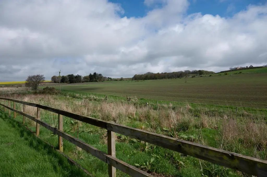 a wooden fence in the middle of a field at Stunning Rural Retreat Sleeps\u00a024 in Aberdeen