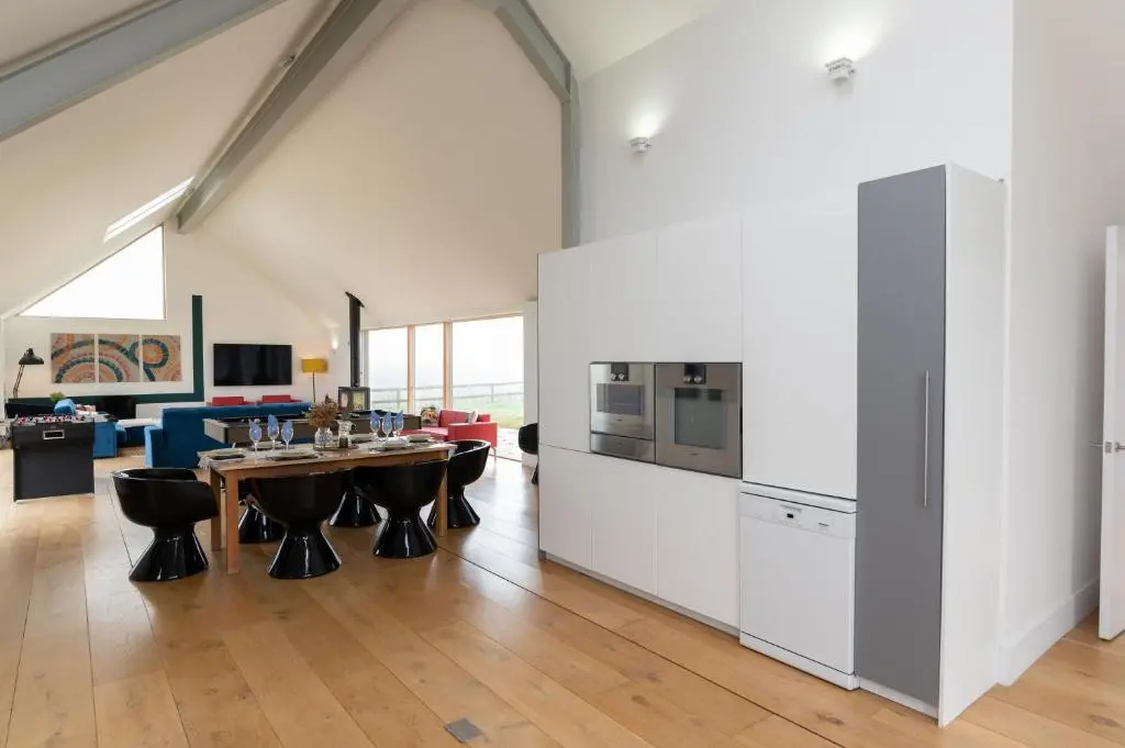 a kitchen and living room with a table and chairs at Stunning Rural Retreat Sleeps\u00a024 in Aberdeen