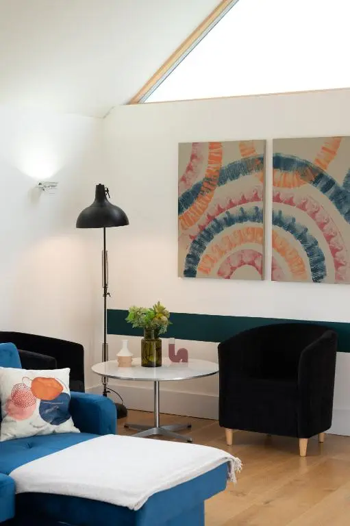 a living room with a blue couch and a table at Stunning Rural Retreat Sleeps\u00a024 in Aberdeen