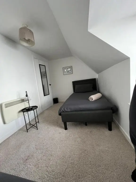 a bedroom with a bed in a attic at MaCaMor in Helmsdale
