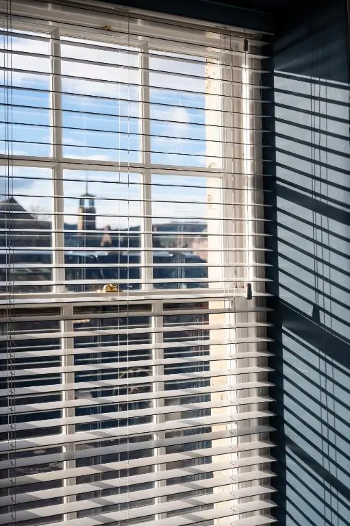 a window with blinds on it with a view of a city at River View City Centre- Free Parking in Inverness