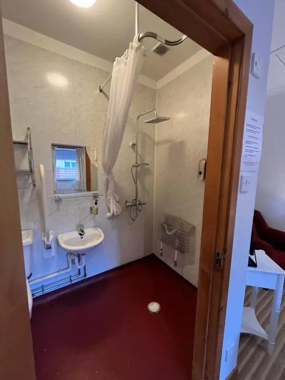 a bathroom with a sink and a mirror at Columba House in Kingussie