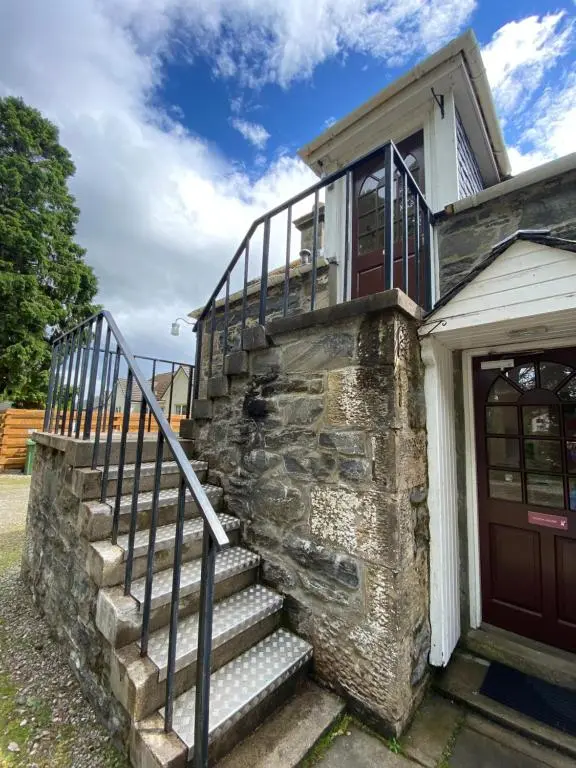 a building with a staircase next to a door at Columba House in Kingussie