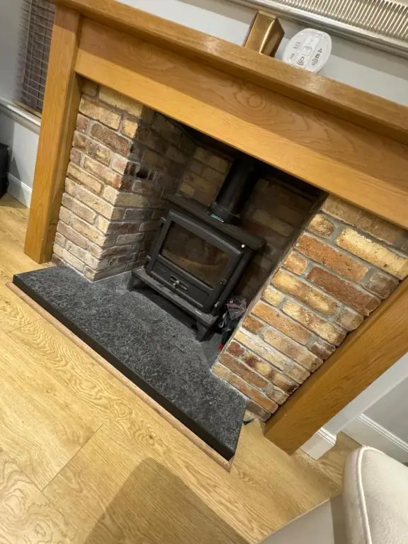 an overhead view of a brick fireplace in a living room at Town Centre 2 bedroom apartment in Wick