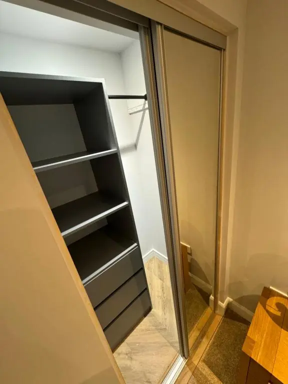 an empty refrigerator with its door open at Town Centre 2 bedroom apartment in Wick