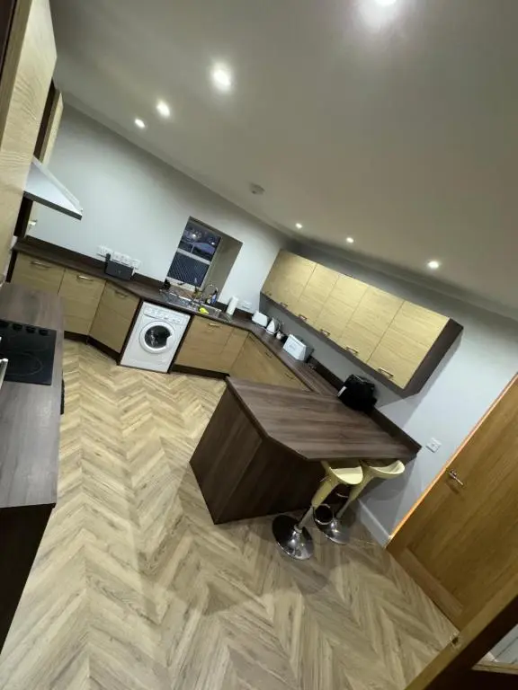 a living room with a desk and a table at Town Centre 2 bedroom apartment in Wick