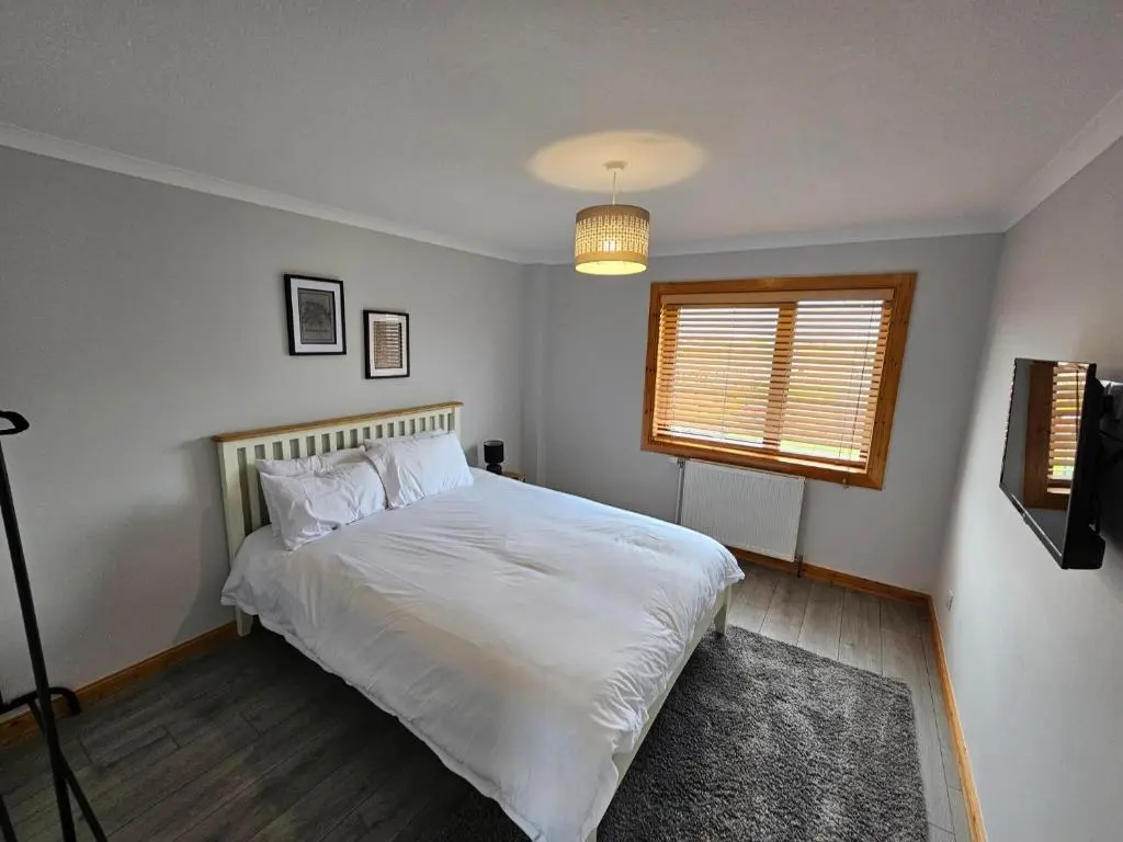 a bedroom with a white bed and a window at NO 40 - 3 bed all with smart tv FULLY FITTED KITCHEN, Spacious living accommodation, FREE PARKING - ideal for TRADES, reduction for LONG STAYS part of Langley Cottages and Apartments in Wick