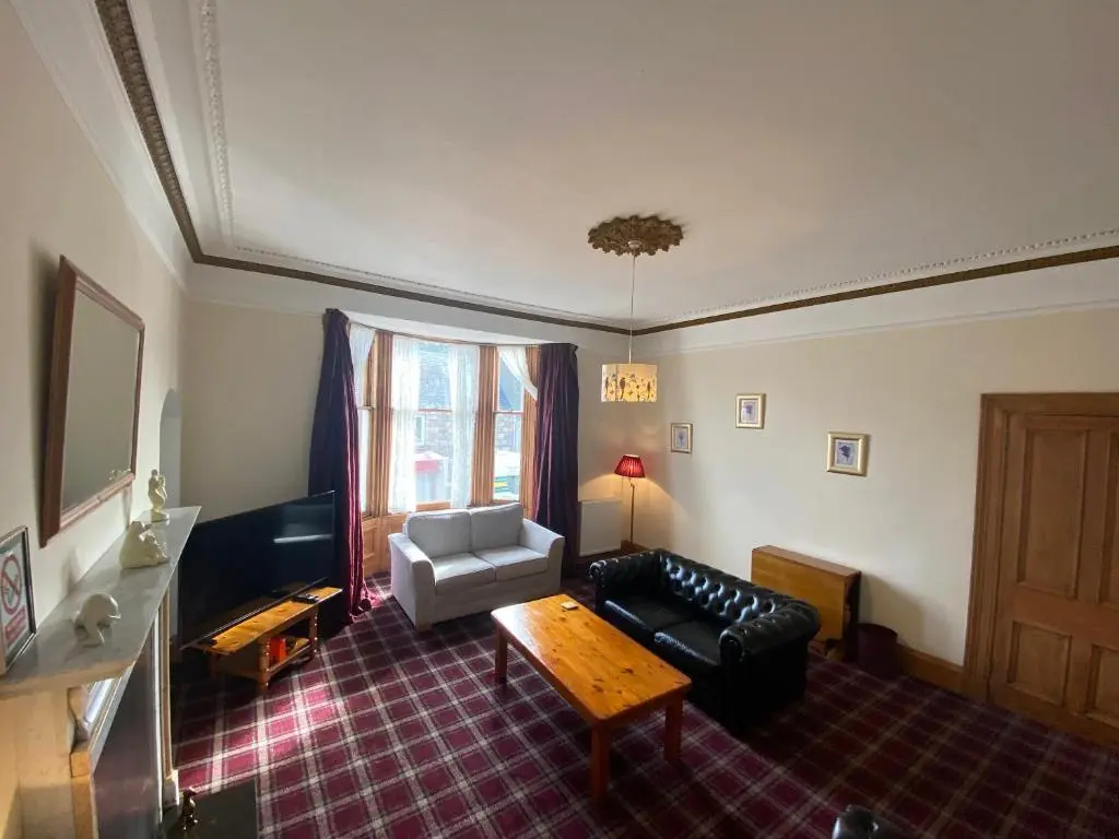 a living room with a couch and a table at 92 High Street in Aberlour