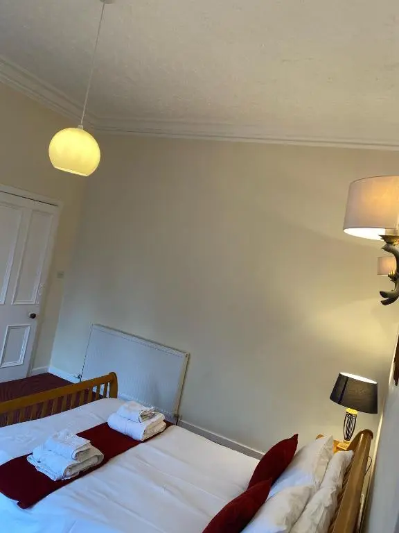 a bedroom with a bed with two towels on it at 92 High Street in Aberlour