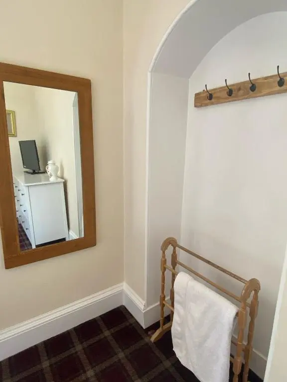 a bathroom with a mirror and a towel rack at 92 High Street in Aberlour