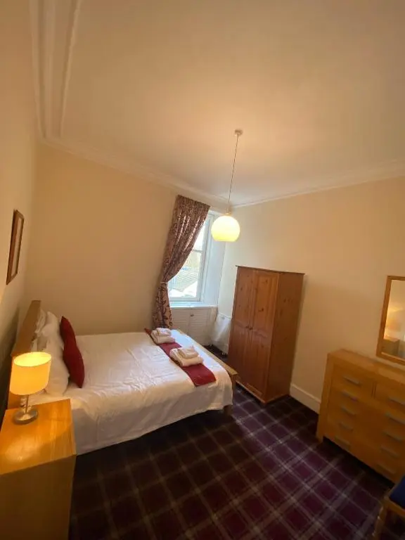 a small bedroom with a bed and a window at 92 High Street in Aberlour