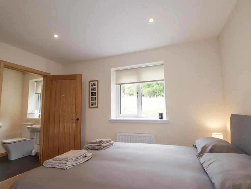 a bedroom with a bed and a window at Crask Bungalow in Beauly