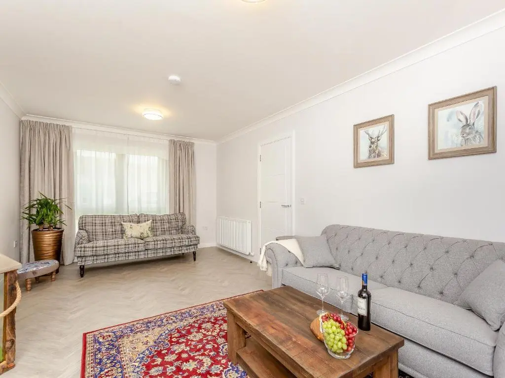 a living room with a couch and a coffee table at The Beech House in Aviemore