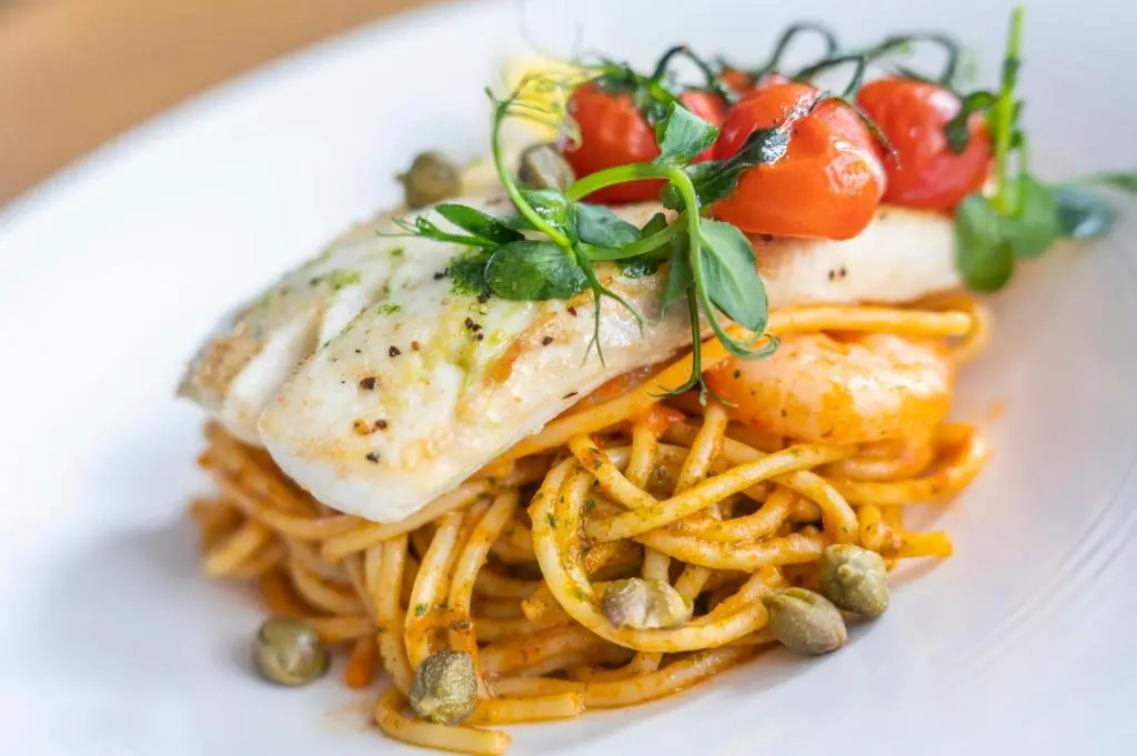 a plate of food with a piece of fish and fries at Heathmount Hotel in Inverness