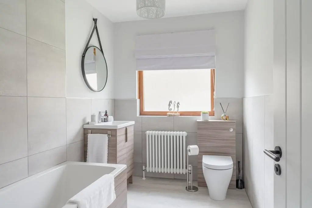 a bathroom with a tub and a toilet and a sink at Gardeners Cottage - Seasgair Lodges in Aviemore
