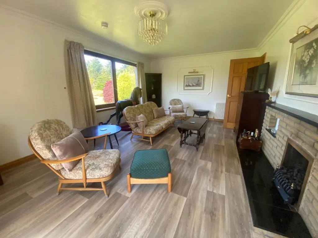 a living room with chairs and a fireplace at Drummond House - Pets welcome free, 3 acres of gardens, free parking in Brackley