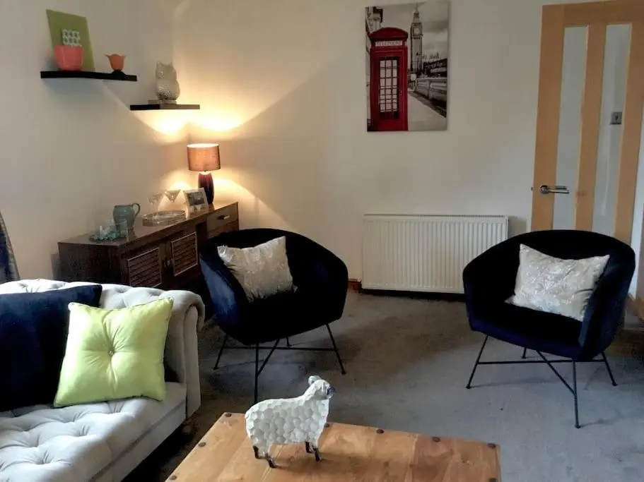 a living room with a couch and two chairs at Bonnie Bide Huntly Aberdeenshire in Huntly