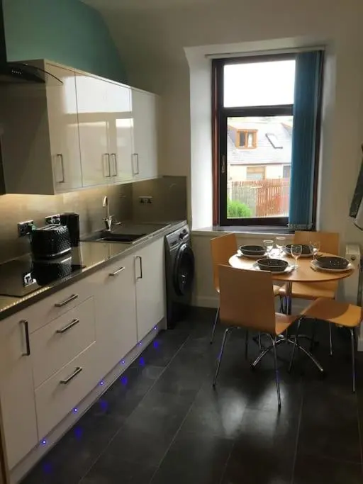 a kitchen with a table and a table and chairs at Bonnie Bide Huntly Aberdeenshire in Huntly