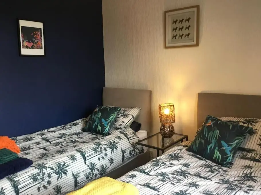 a room with two beds and a lamp in it at Bonnie Bide Huntly Aberdeenshire in Huntly