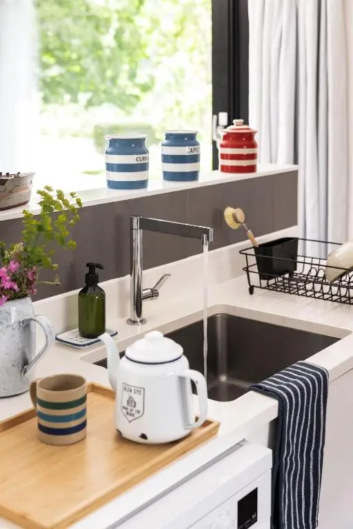 a kitchen counter with a tea kettle and a sink at Number 5 Steading Cottage in Banchory