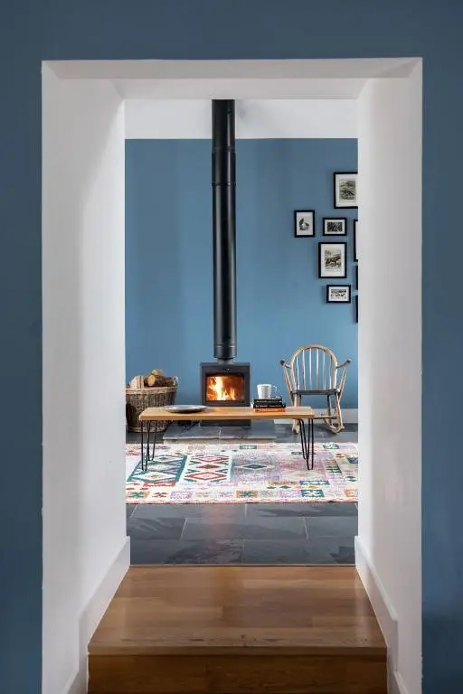 a living room with a table and a fireplace at Number 5 Steading Cottage in Banchory