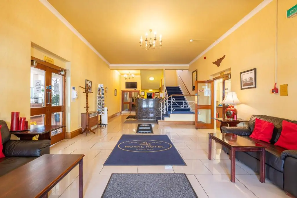 a living room with couches and a rug on the floor at The Royal Hotel in Ullapool