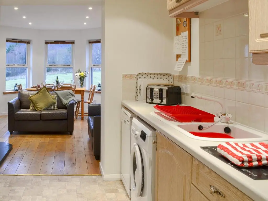 a kitchen with a sink and a counter top at Birch Tree Cottage in Aviemore