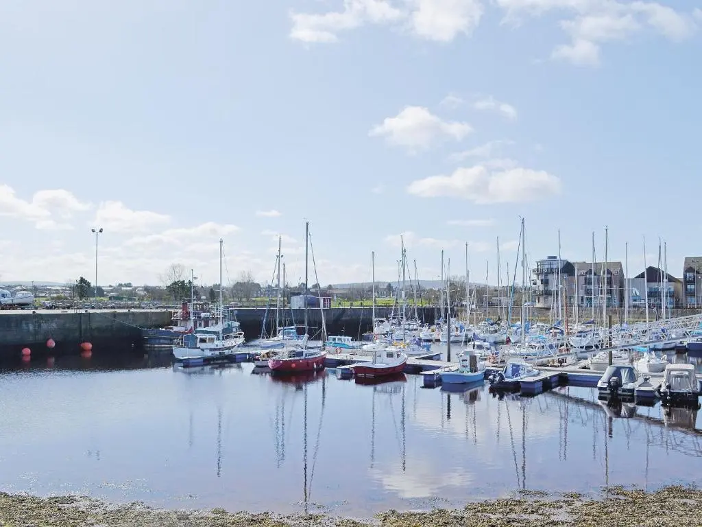 a bunch of boats docked in a harbor at Sandy Beach in Nairn