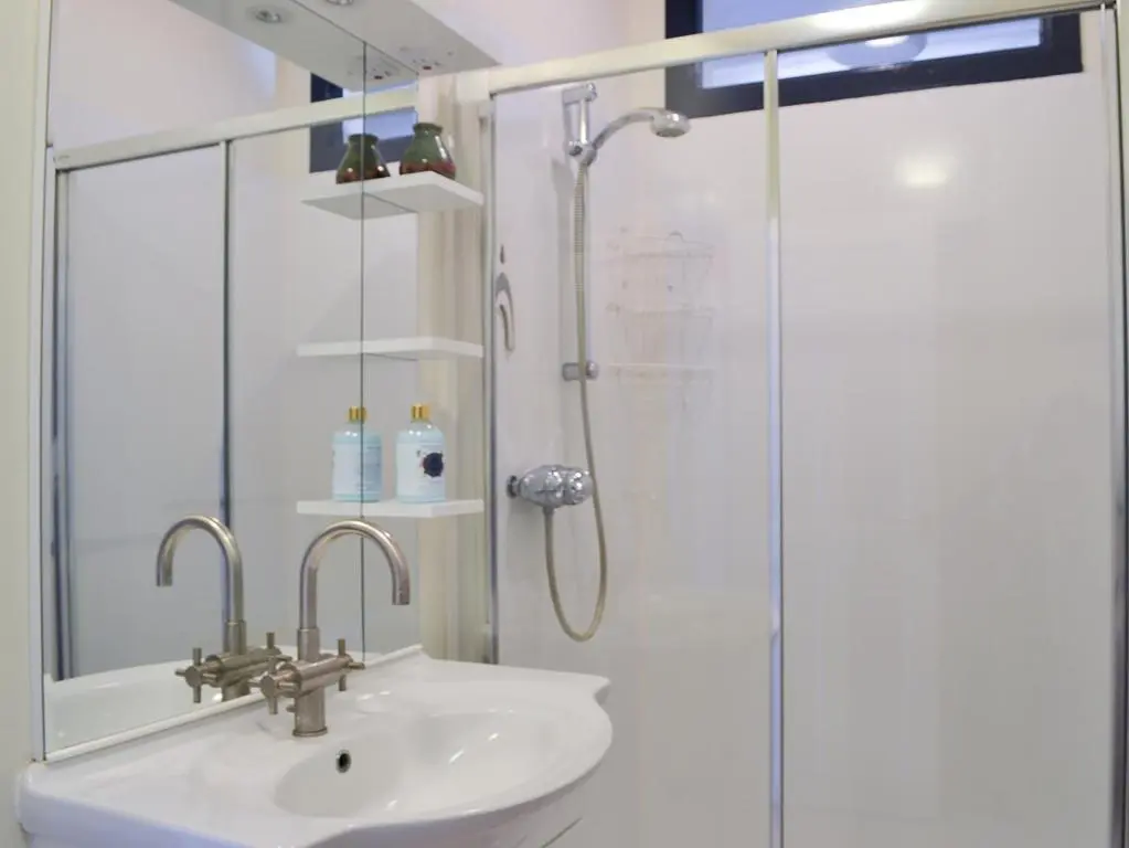a bathroom with a sink and a shower at Langside in Kingussie