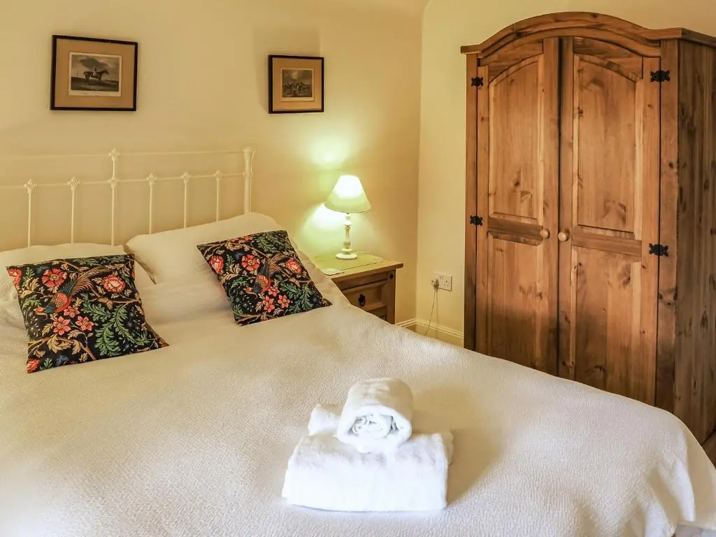 a bedroom with a bed with a towel on it at Einich in Newtonmore