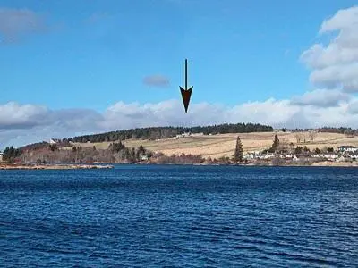 a kite flying over a large body of water at Reid's Cottage in Lairg