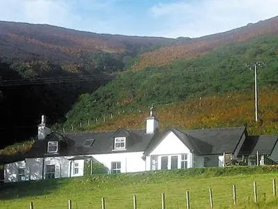 a white house in the middle of a field at Owl Cottage in Kilmote