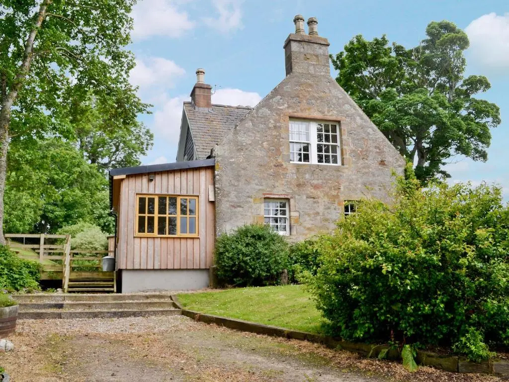 an old stone house with a gambrel roof at The Cottage in Ankerville