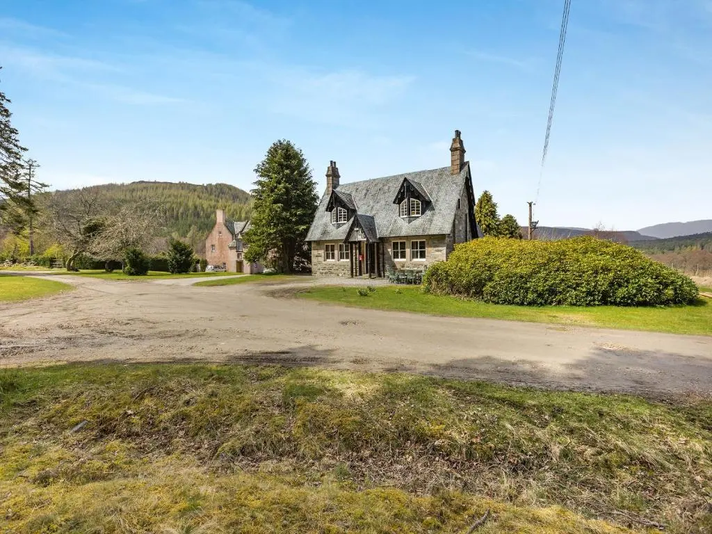 an old house on a dirt road in front at The Knock in Inverey