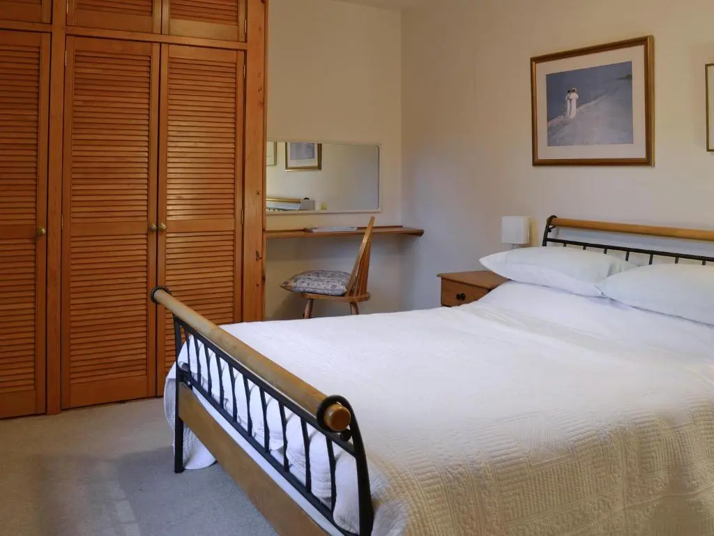 a bedroom with a large bed and a desk at Laird's Cast in Banchory