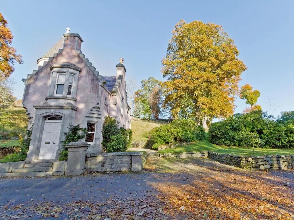 an old house on a hill with trees at Dess Lodge in Kincardine O\u02bcNeil