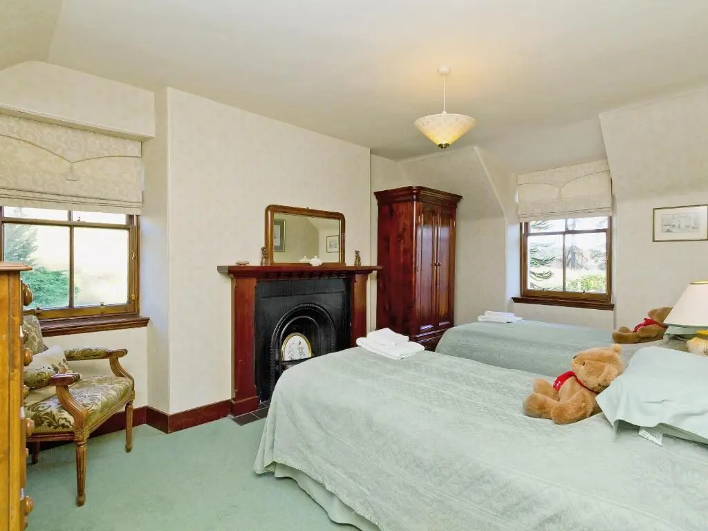 a bedroom with two beds and a teddy bear on the bed at Dess Lodge in Kincardine O\u02bcNeil
