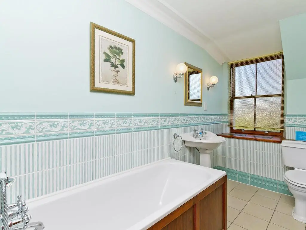 a bathroom with a tub and a toilet and a sink at Dess Lodge in Kincardine O\u02bcNeil